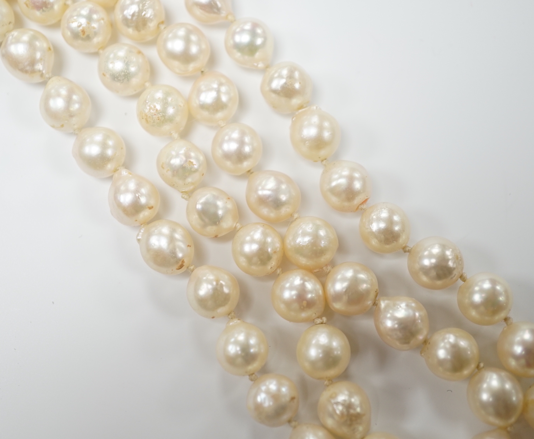 A modern single strand cultured baroque pearl necklace, with 9ct and sapphire set clasp, 66cm.